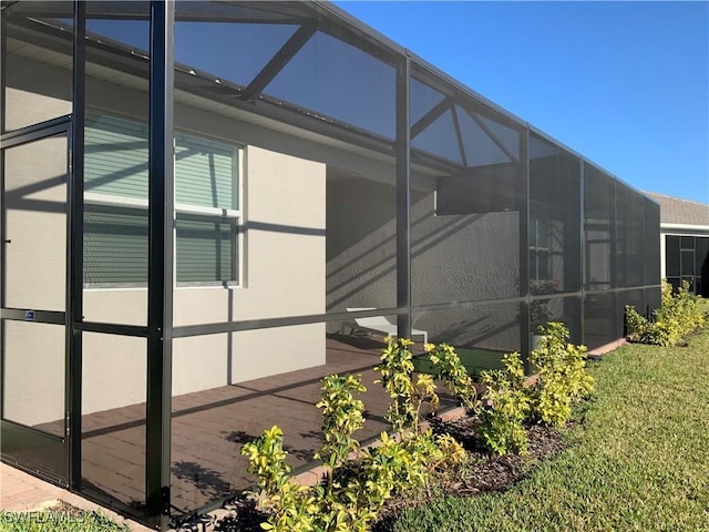 view of home's exterior featuring glass enclosure