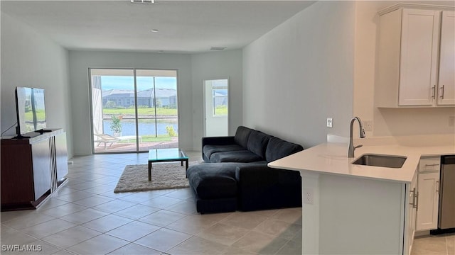 tiled living room with a water and mountain view and sink