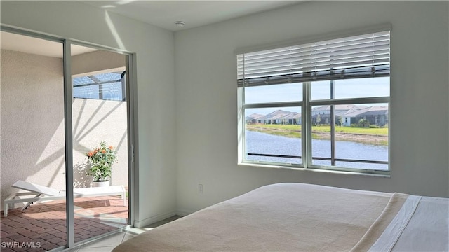 unfurnished bedroom featuring a water view