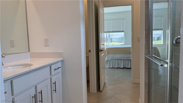 bathroom with tile patterned floors, vanity, and an enclosed shower