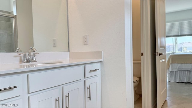 bathroom featuring vanity, an enclosed shower, and toilet