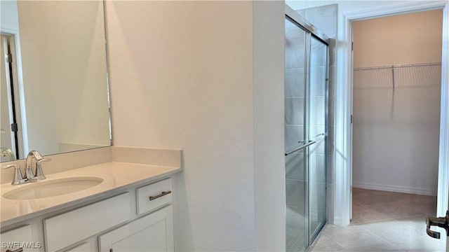 bathroom with vanity, tile patterned floors, and walk in shower