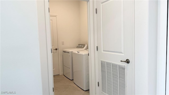 laundry room featuring light tile patterned floors and independent washer and dryer