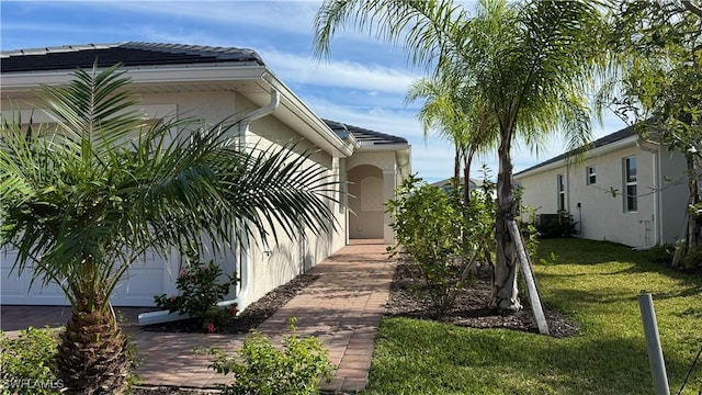 view of property exterior featuring a yard and a garage