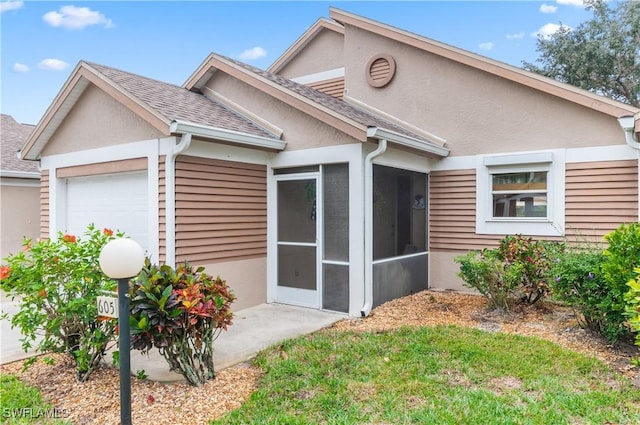 view of front of property with a sunroom and a garage