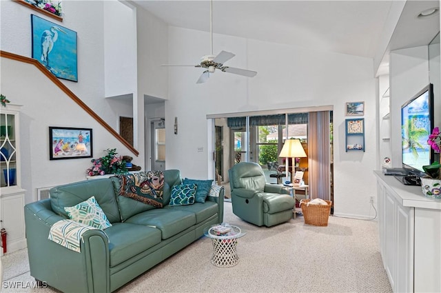 living room with light colored carpet, high vaulted ceiling, and ceiling fan