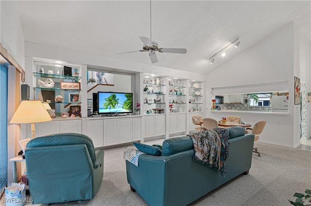 living room with built in shelves, ceiling fan, light colored carpet, a textured ceiling, and lofted ceiling