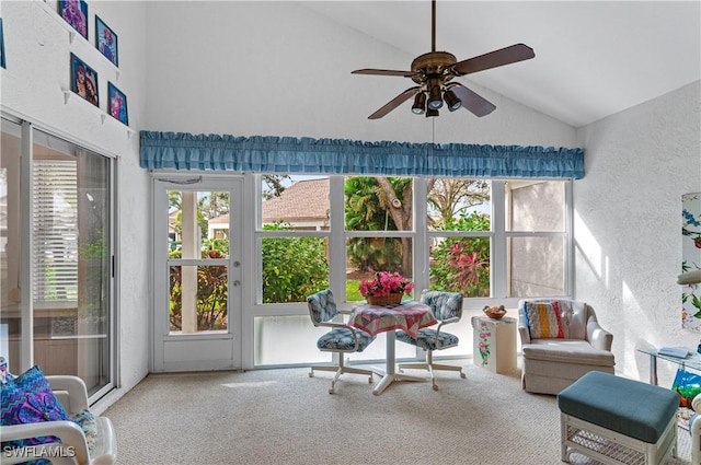 sunroom / solarium with a wealth of natural light, ceiling fan, and vaulted ceiling