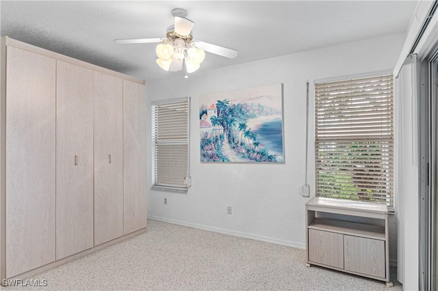 unfurnished bedroom featuring ceiling fan