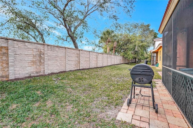 view of yard featuring a patio and a sunroom