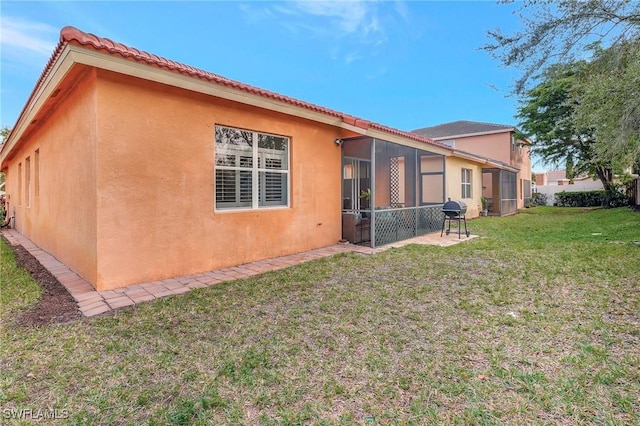 rear view of property with a lawn