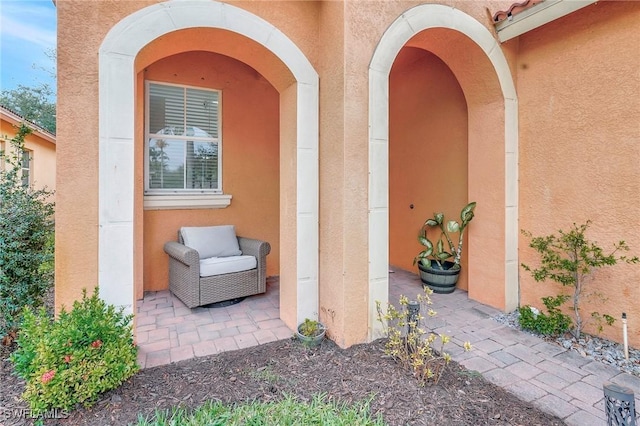 doorway to property with a patio area