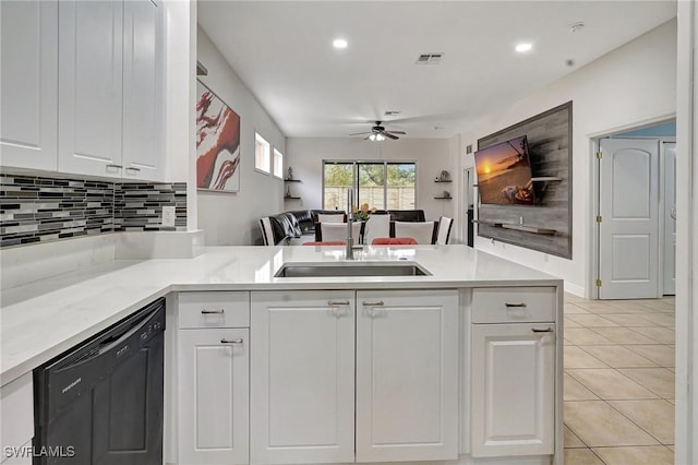 kitchen with light tile patterned floors, white cabinets, dishwasher, and kitchen peninsula