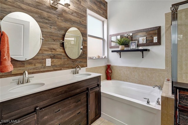 bathroom featuring vanity, a tub, and tile patterned floors