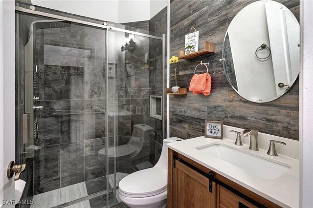 bathroom featuring an enclosed shower, vanity, and toilet