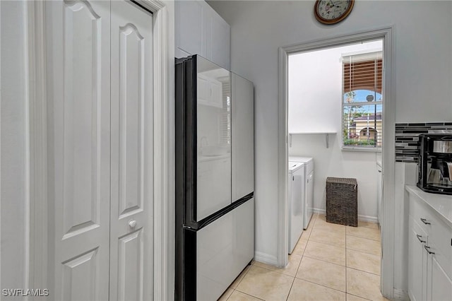 bathroom with separate washer and dryer and tile patterned floors