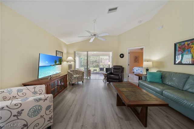 living room featuring ceiling fan, wood-type flooring, and lofted ceiling