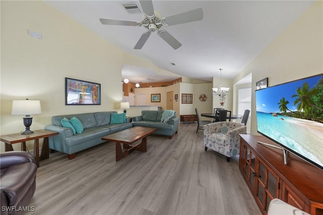 living room featuring ceiling fan with notable chandelier, lofted ceiling, and light hardwood / wood-style flooring