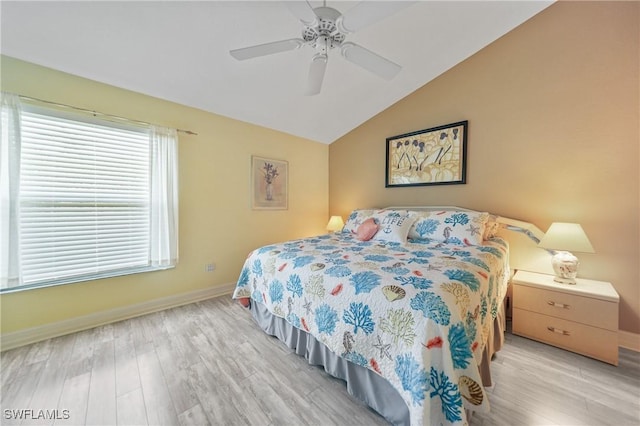 bedroom featuring ceiling fan, light hardwood / wood-style flooring, and vaulted ceiling