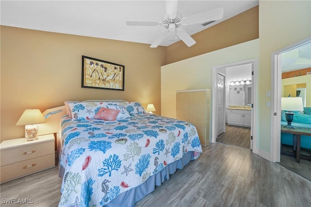 bedroom with wood-type flooring, ensuite bath, and ceiling fan