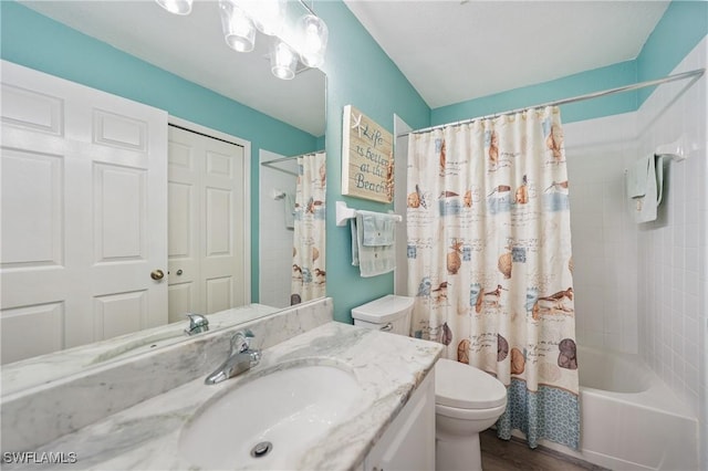 full bathroom featuring shower / bath combo, vanity, and toilet