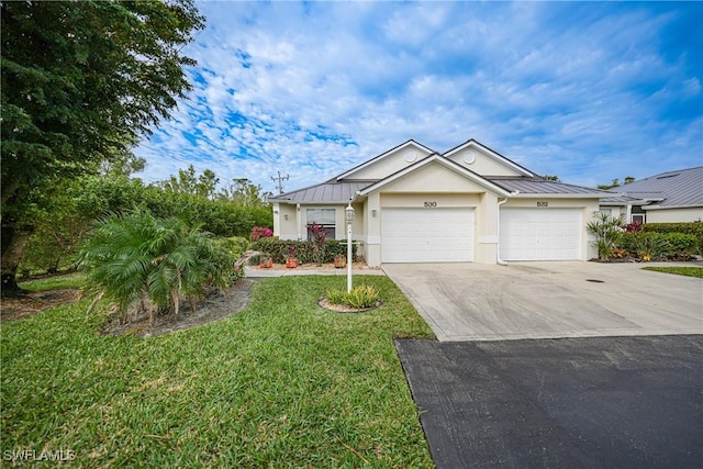 view of front of property with a front lawn and a garage