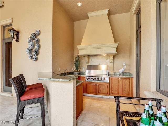 view of patio / terrace featuring a grill and exterior kitchen