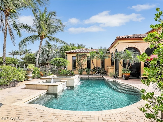 view of swimming pool with an in ground hot tub and a patio