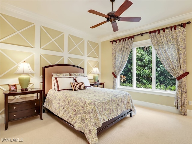 carpeted bedroom featuring crown molding and ceiling fan