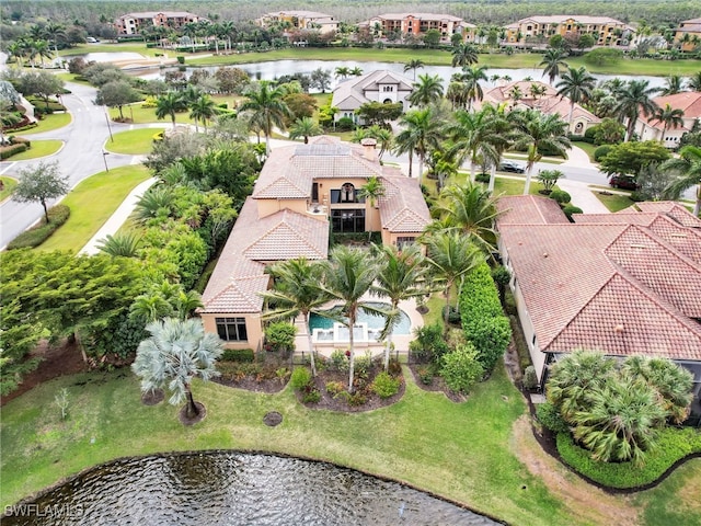 birds eye view of property with a water view