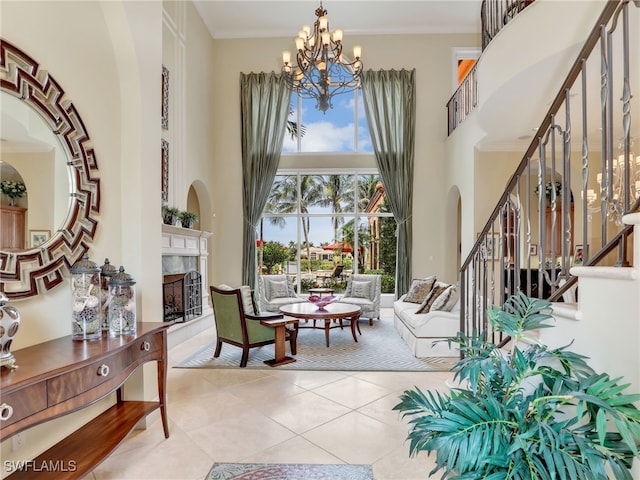 sitting room featuring crown molding, a chandelier, light tile patterned floors, and a high ceiling