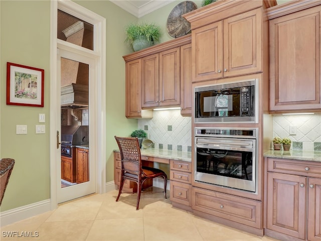 kitchen featuring black microwave, ornamental molding, stainless steel oven, light tile patterned floors, and light stone countertops