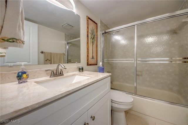 full bathroom with toilet, tile patterned floors, enclosed tub / shower combo, and vanity