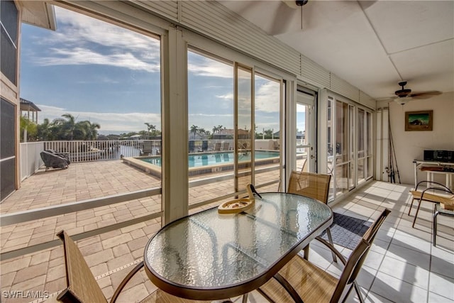 sunroom / solarium featuring ceiling fan