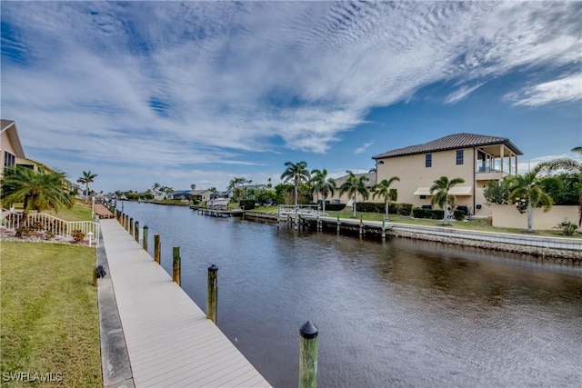 view of dock featuring a yard and a water view