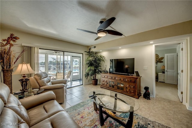 tiled living room with ceiling fan