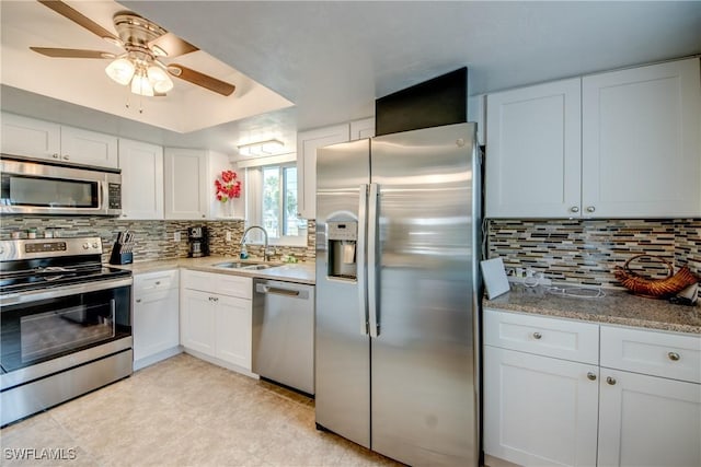 1118 SW 48th Ter Unit 104, Cape Coral, FL 33914 - kitchen with appliances with stainless steel finishes, a sink, ceiling fan, and decorative backsplash