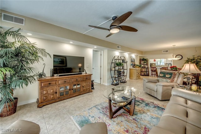 living room with ceiling fan and light tile patterned flooring