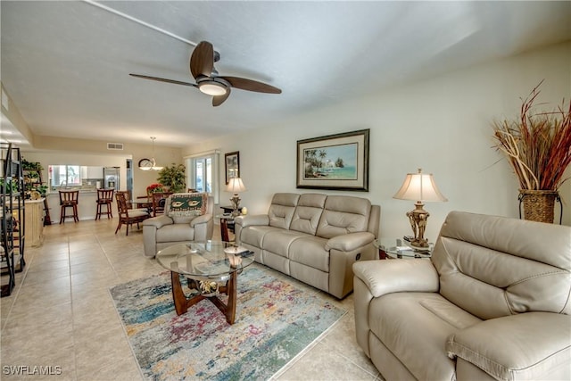 tiled living room featuring ceiling fan