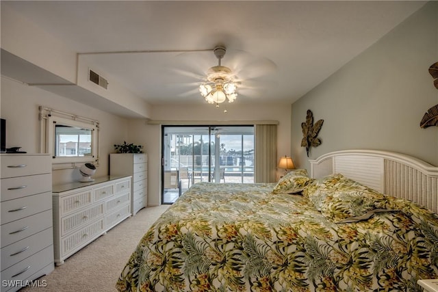 bedroom with multiple windows, light colored carpet, access to exterior, and ceiling fan