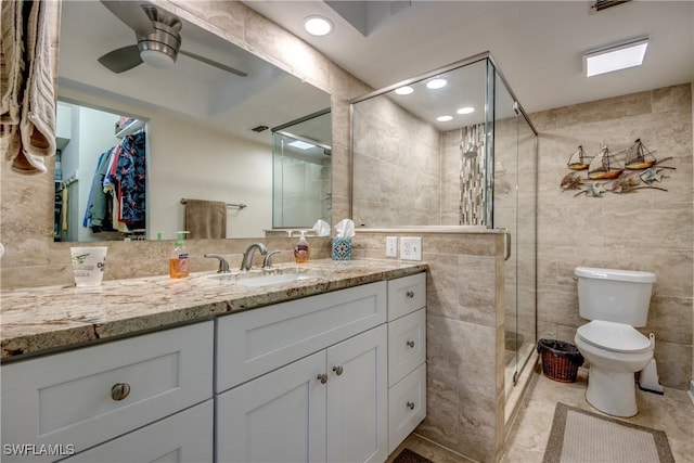 1118 SW 48th Ter Unit 104, Cape Coral, FL 33914 - full bath featuring tile walls, a stall shower, ceiling fan, vanity, and toilet