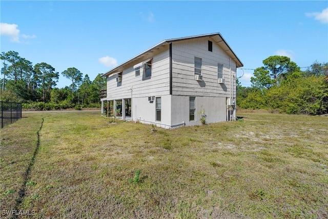 rear view of property with a yard