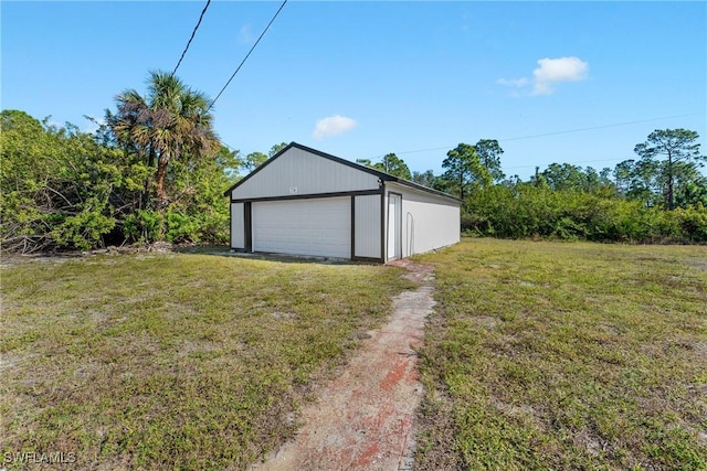 garage featuring a lawn