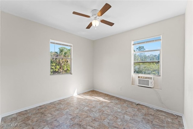 spare room with cooling unit and ceiling fan