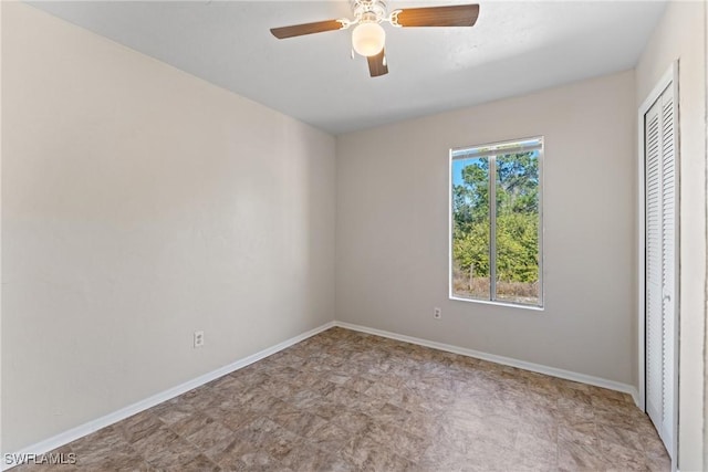 unfurnished bedroom featuring multiple windows, a closet, and ceiling fan