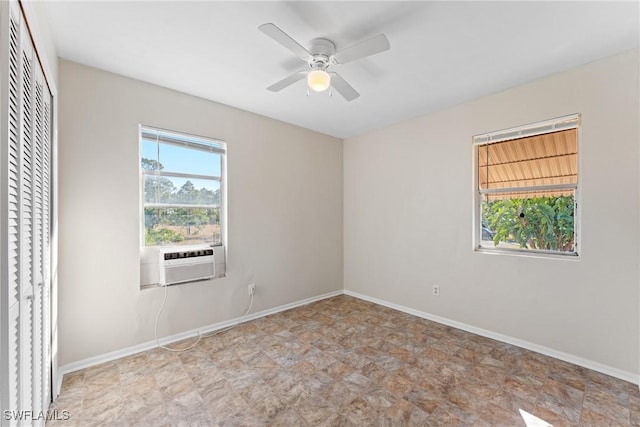 unfurnished room featuring ceiling fan, cooling unit, and a wealth of natural light