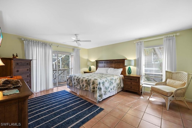 tiled bedroom featuring ceiling fan, multiple windows, and access to outside