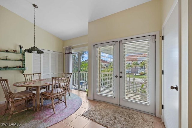 tiled dining space with french doors and lofted ceiling