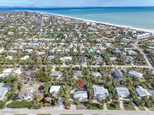 bird's eye view with a water view and a view of the beach