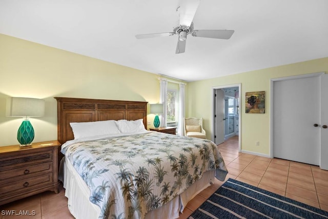 bedroom with ceiling fan, light tile patterned floors, and ensuite bathroom